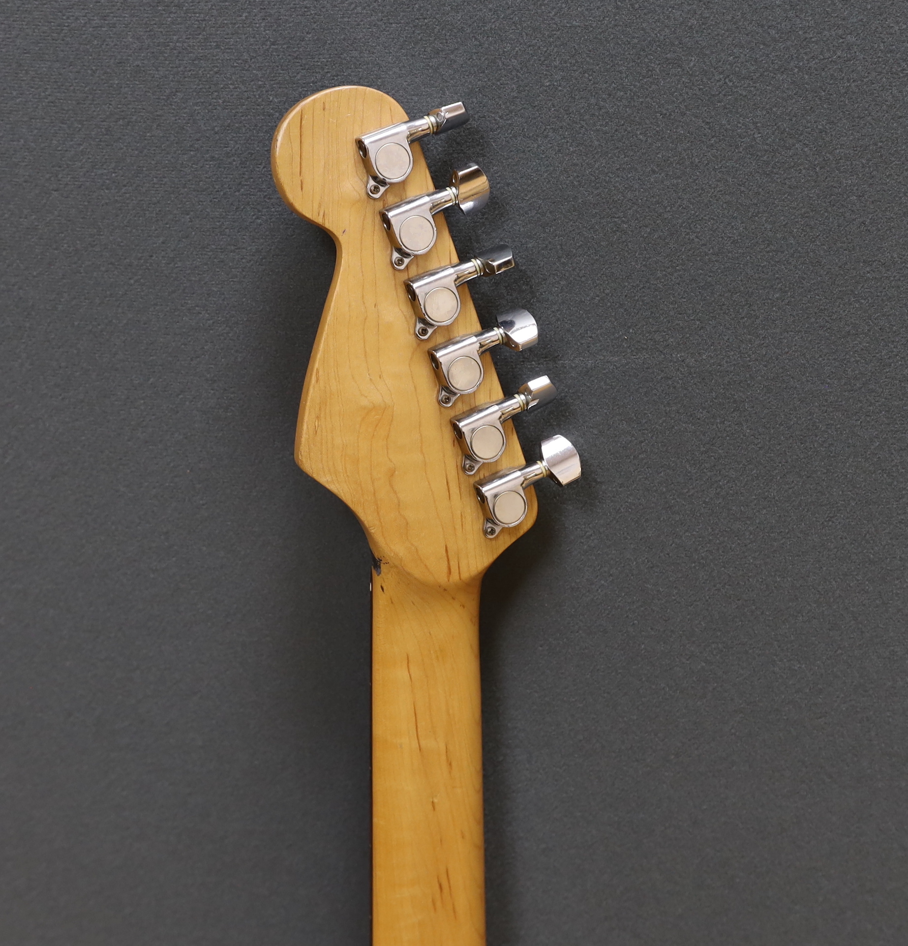 A cased Squier Strat by Fender electric guitar with rosewood neck and balance lacquer body, together with a Harris Tweed flight case